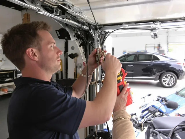 Watertown Garage Door Repair safety certified technician performing cable replacement in Watertown